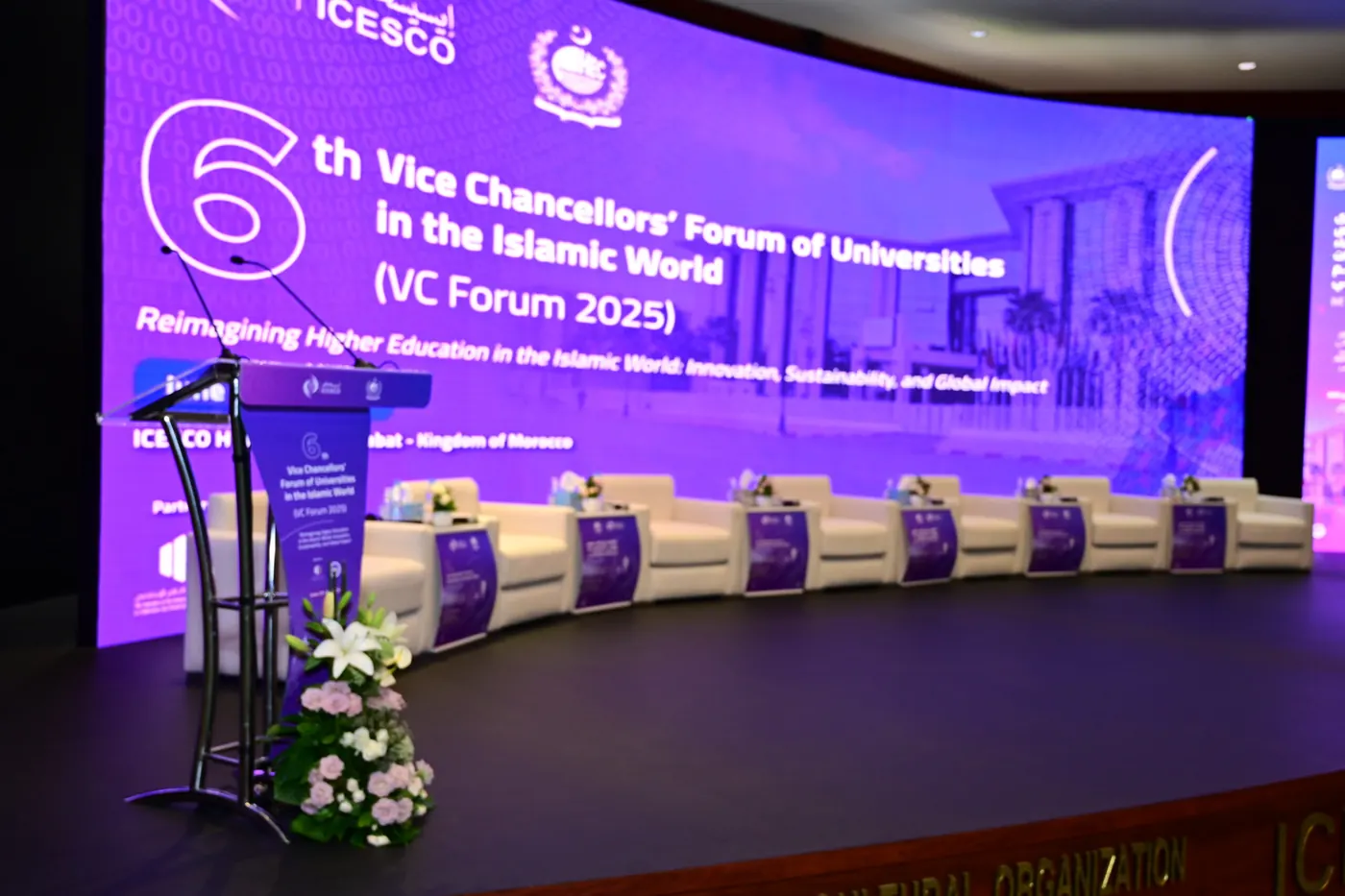 The ICESCO Vice Chancellors’ Forum stage, a curved purple LED wall above a row of white armchairs.