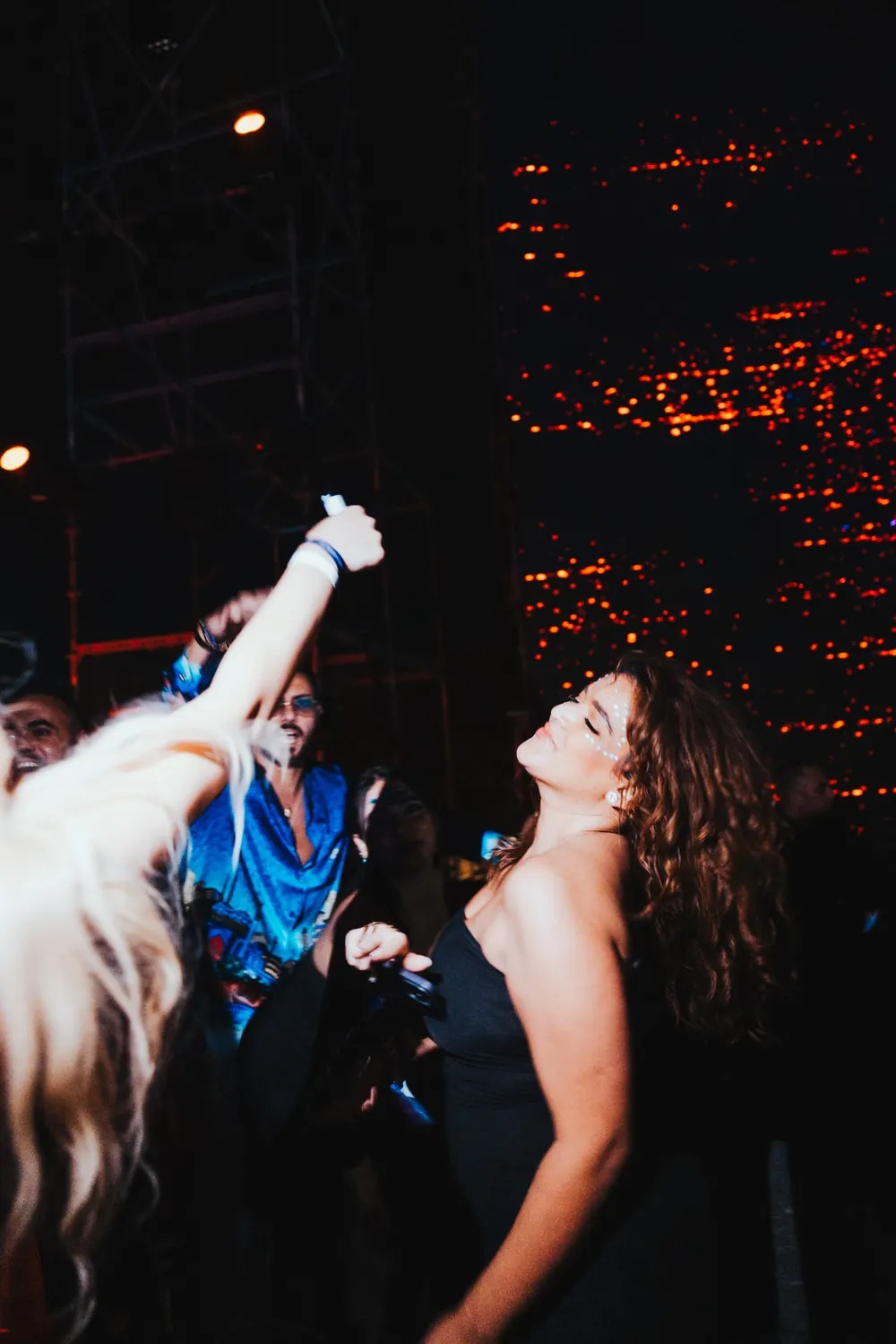 Two guests dancing under warm lights.